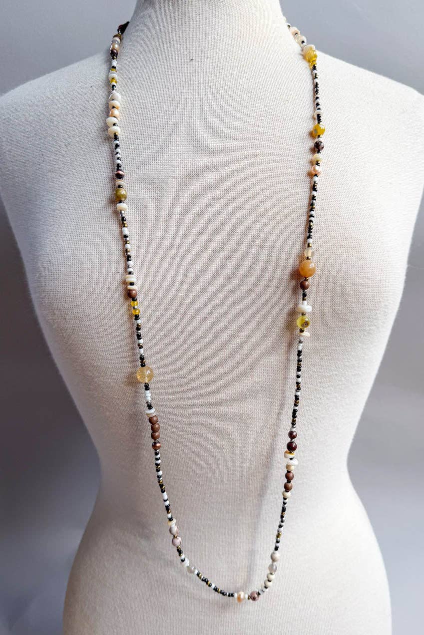 Beaded necklace on a mannequin with a plain background