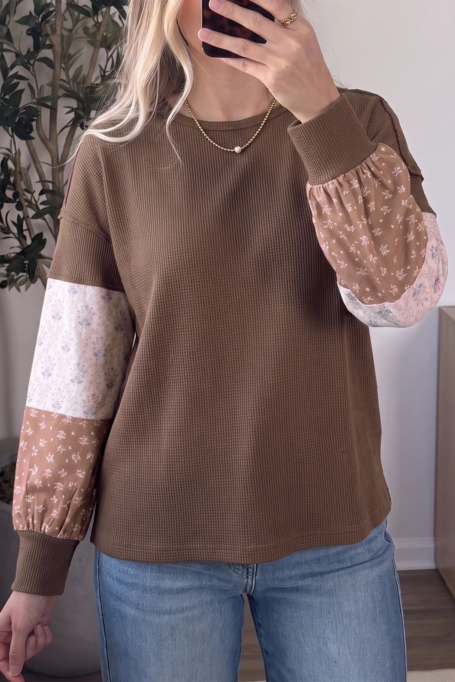 Mocha waffle knit tunic top with blush and cream floral colorblock patchwork long sleeves styled with light wash jeans and gold necklace