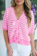 Woman wearing a pink and white striped sweater with a blurred background